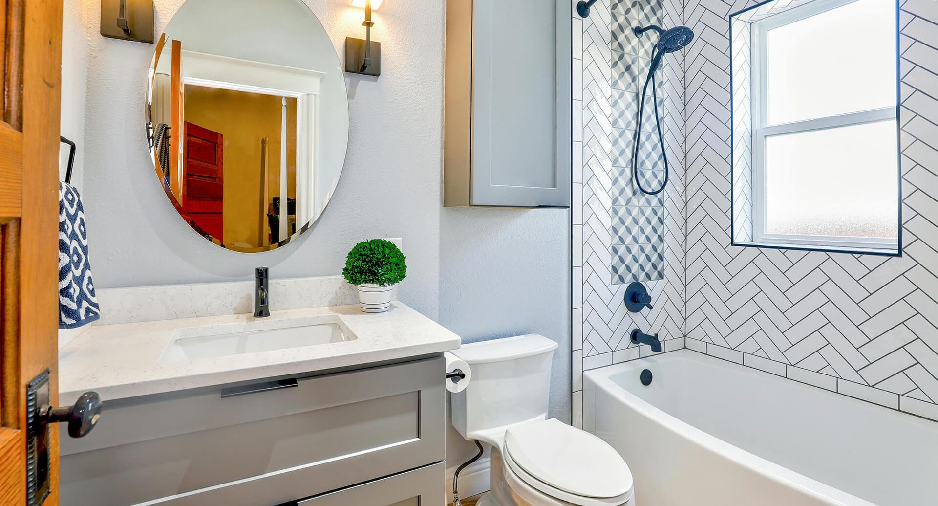 A bathroom with a toilet, sink and tub.