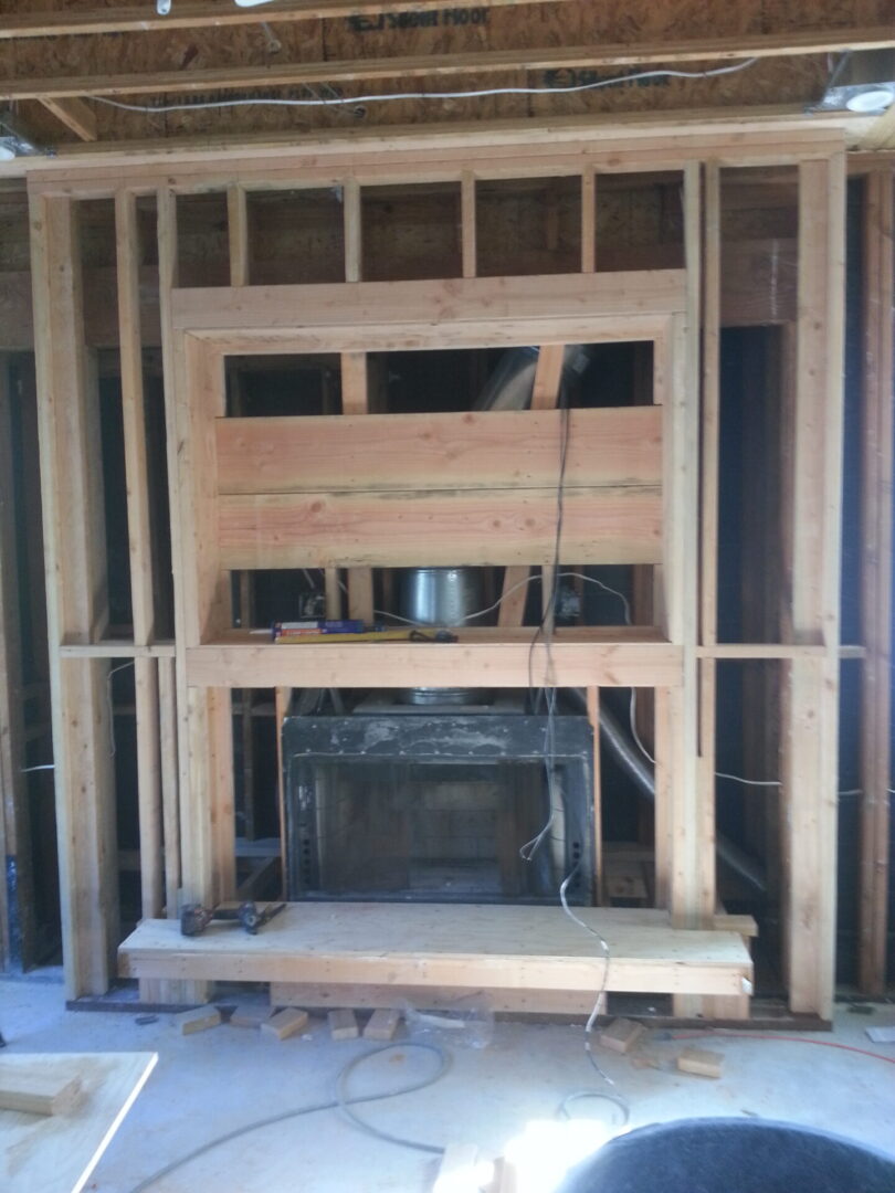 A fireplace being built in the middle of a house.