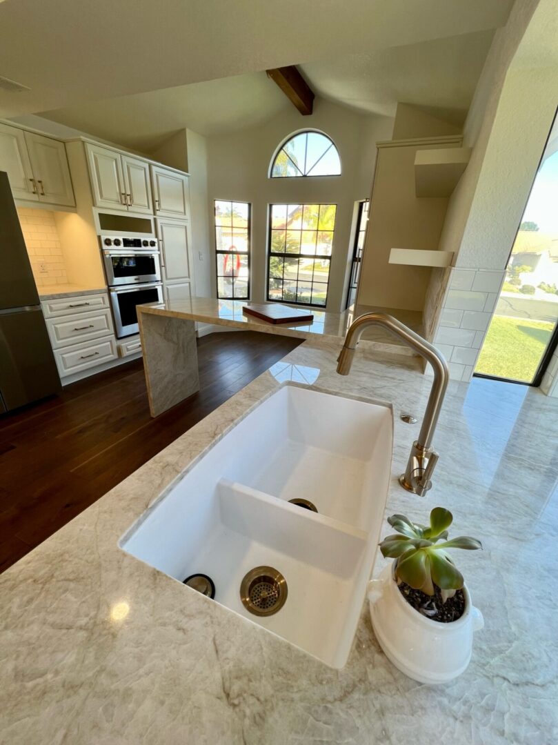 A kitchen with an island and sink in it