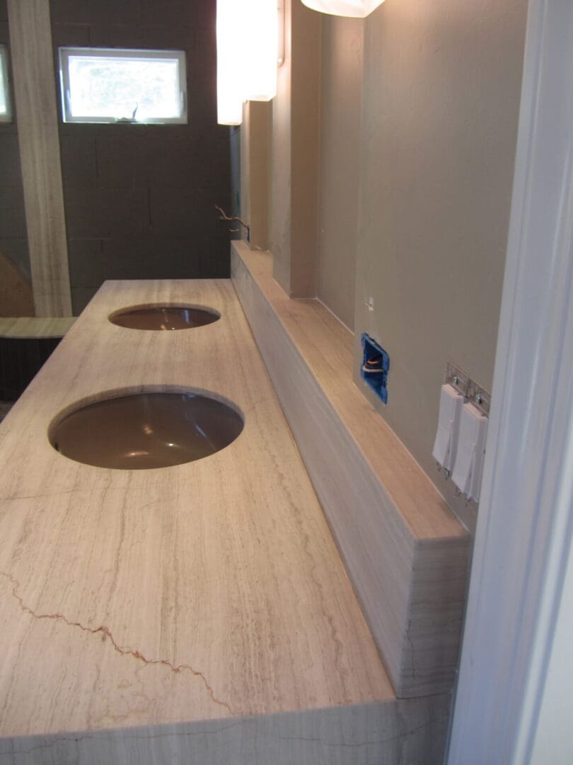 A bathroom with two sinks and a mirror.