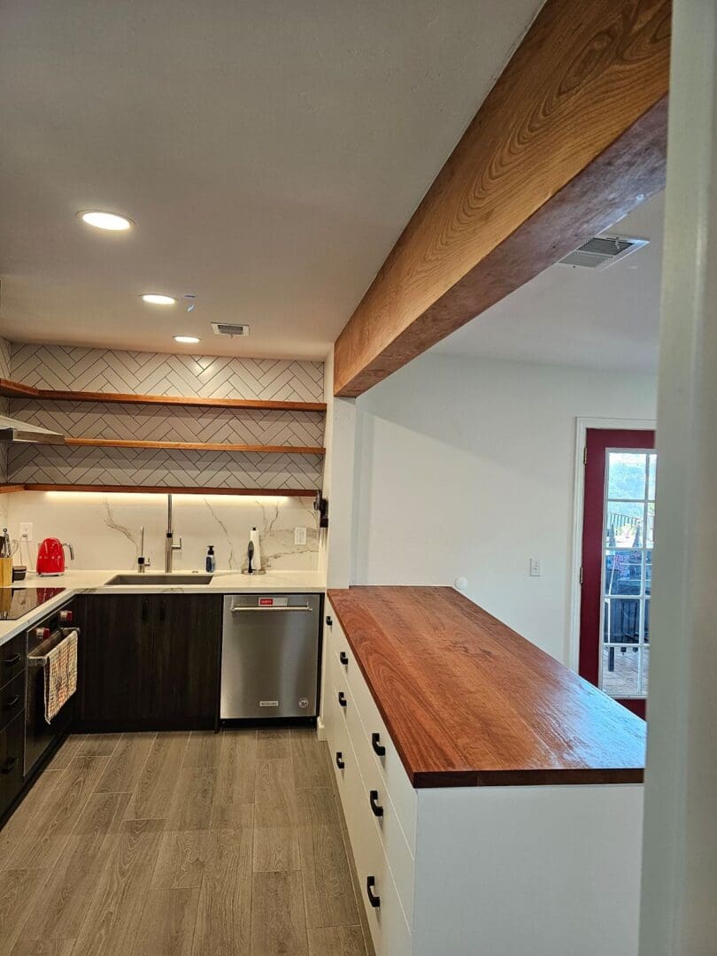 A kitchen with wooden counters and white cabinets.