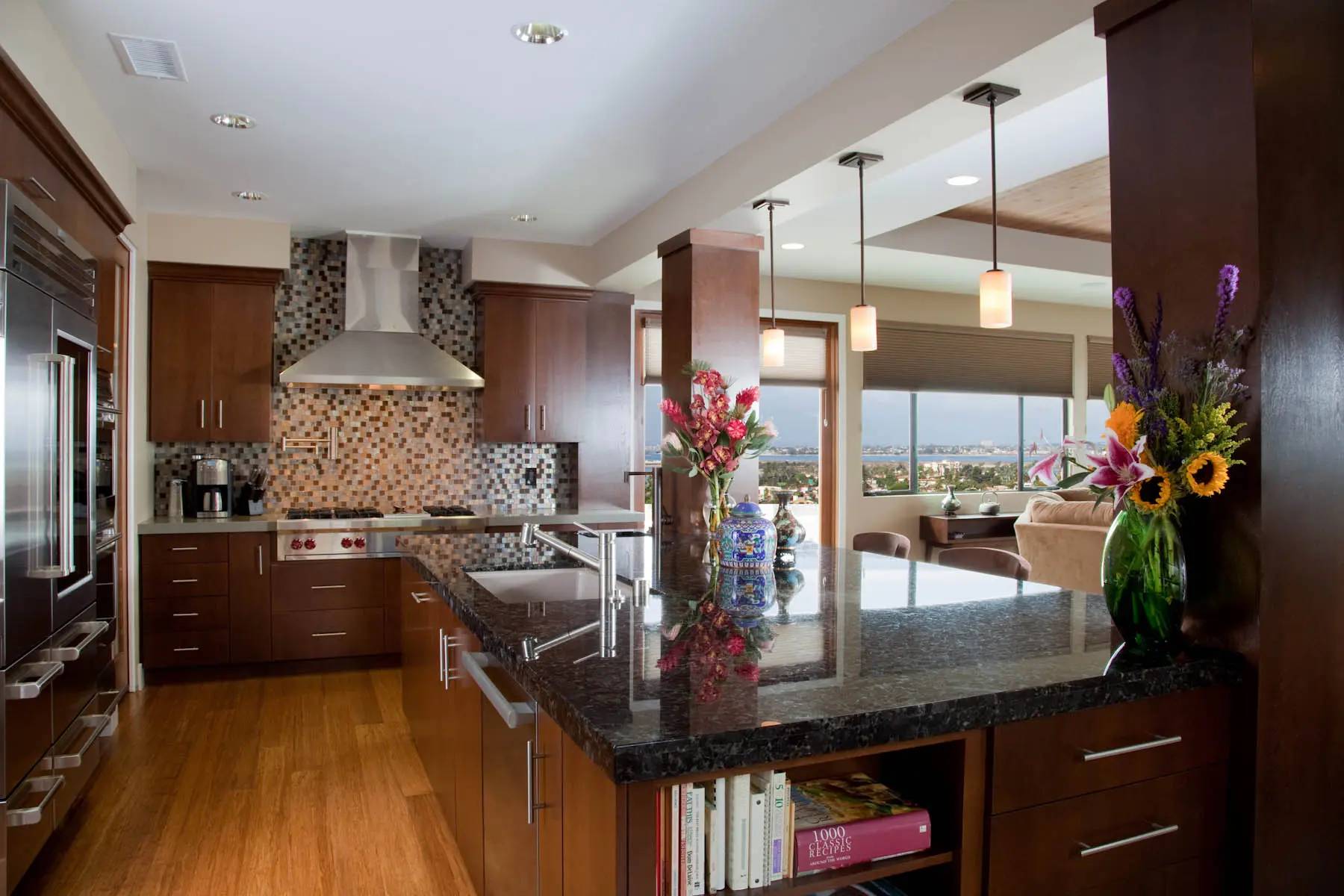 A kitchen with a large island and wooden cabinets.