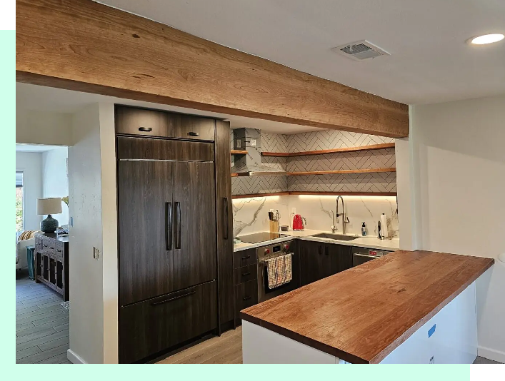 A kitchen with wooden cabinets and wood counter tops.